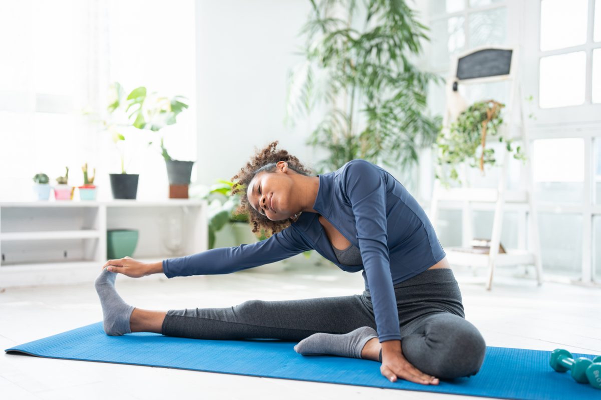 Young Woman Doing Yoga Exercise At Home