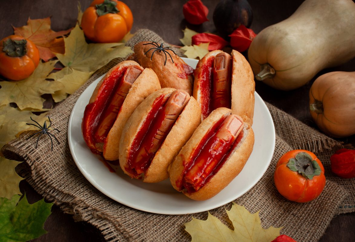 Halloween Food. Halloween Hot Dog. Bloody Fingers From Sausages In Rolls With Ketchup. Scary Food. Themed Food. Dark Wooden Background.