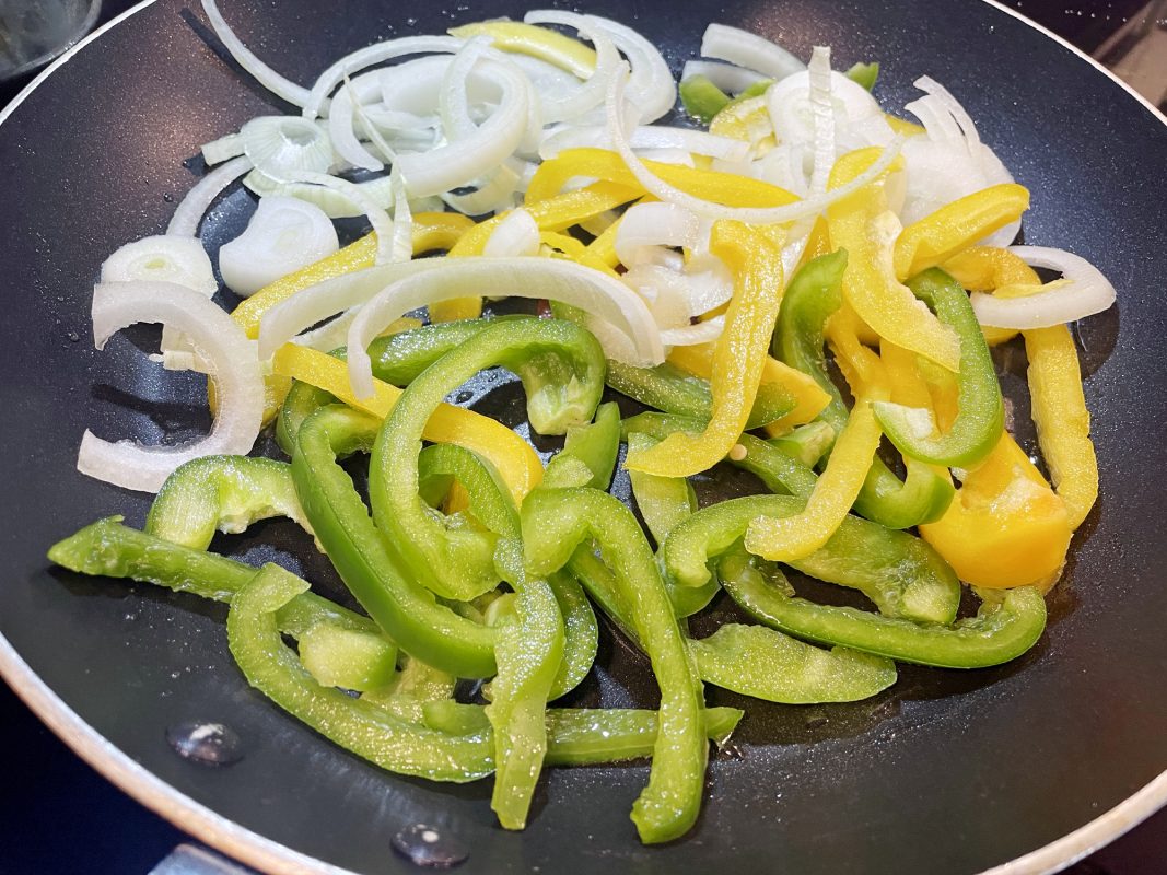 Peppers And Onions In Frying Pan