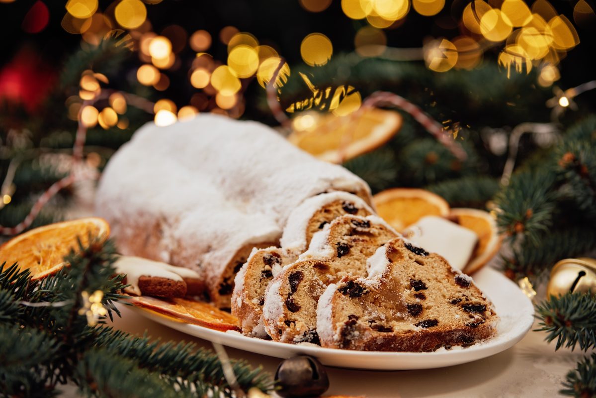 Christmas Stollen On Wooden Background. Traditional Christmas German Dessert Cut Into Pieces.