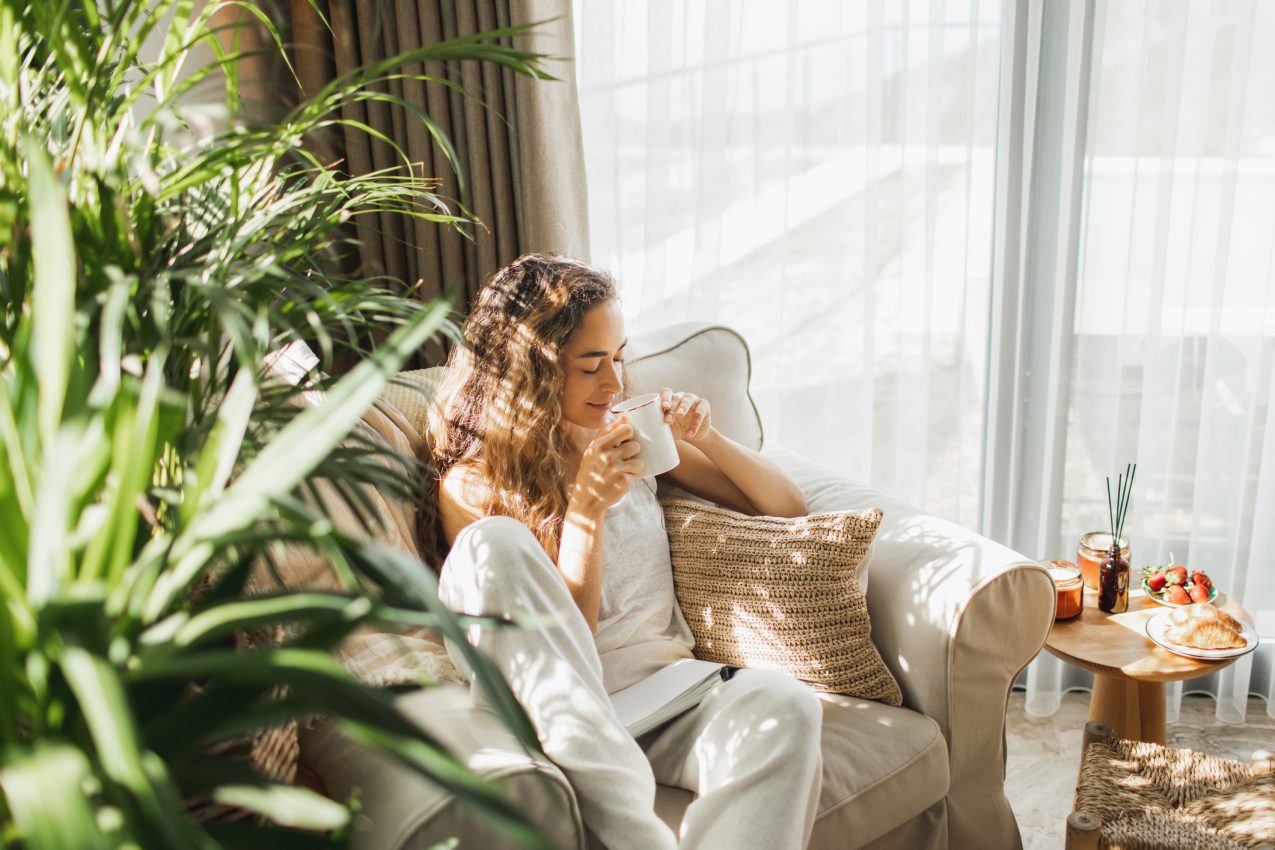 Woman At Home Reading Book And Drinking Coffee.